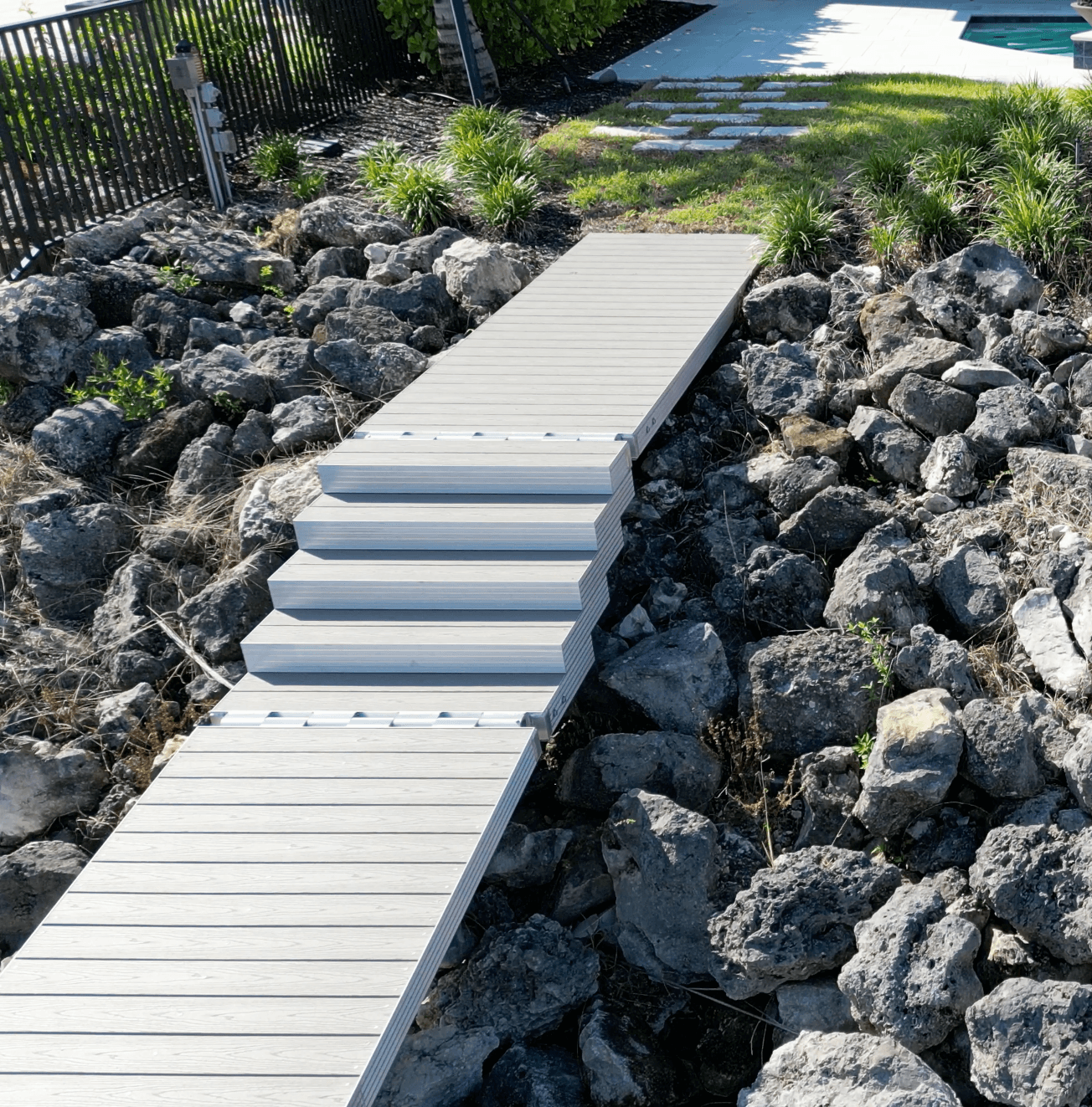 Aluminum gangway stairs providing access from shoreline to dock.