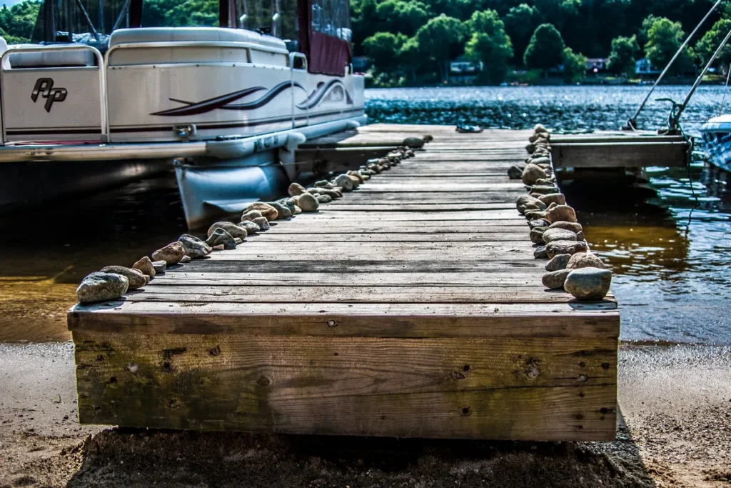 Boats moored at a jetty on a lake, highlighting the importance of quality dock building for homeowners.